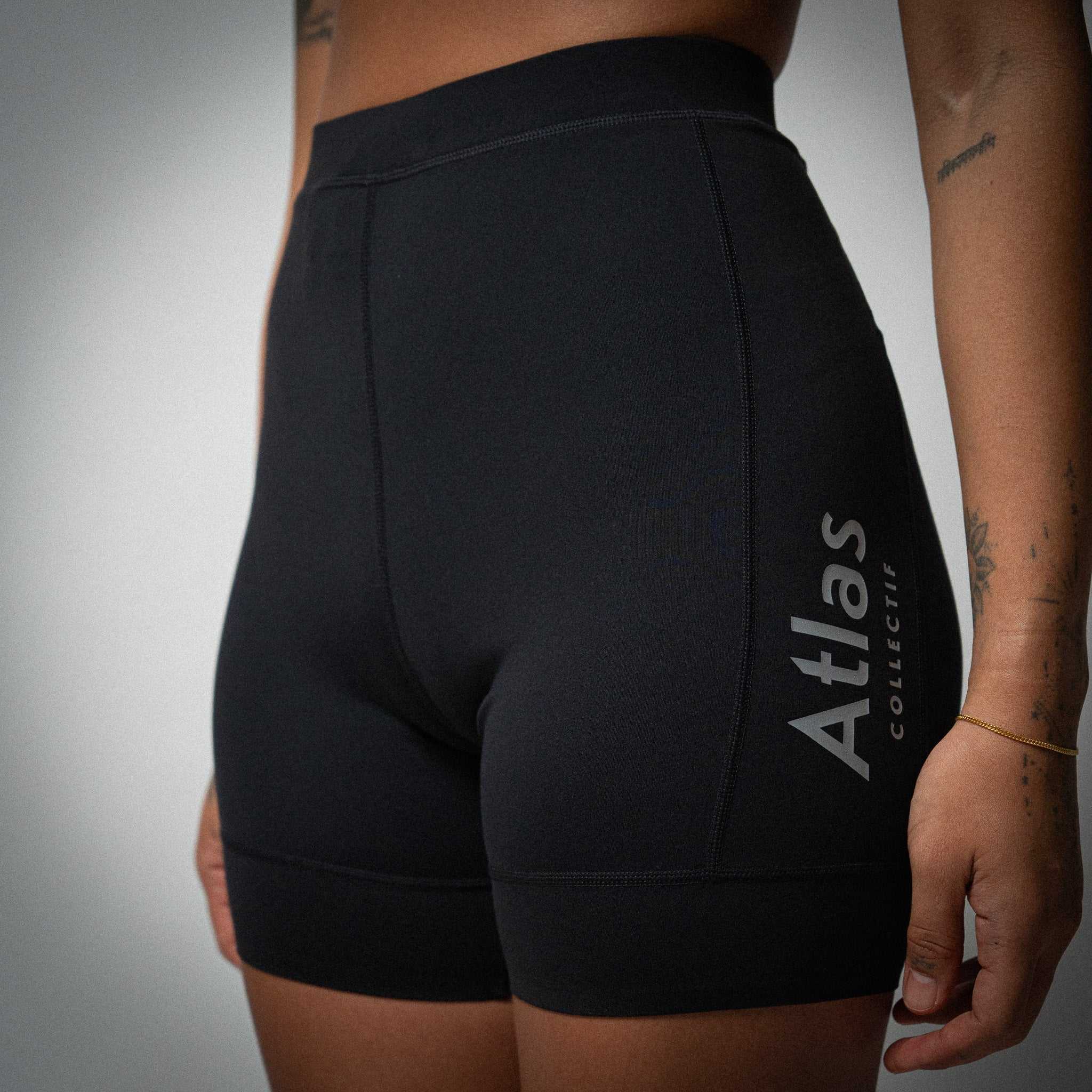 Illumi Trax WMNS Running Half Tights in black with reflective detailing and storage pockets.